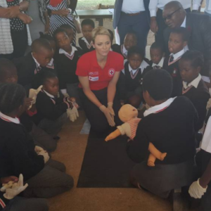 La princesse Charlene de Monaco montre les gestes de premiers secours et de réanimation cardio-pulmonaire lors d'une visite à l'école primaire Gugulesizwe à Benoni en Afrique du Sud, où elle avait lancé en 2012 sa fondation. Photo Instagram @saredcross (Croix-Rouge sud-africaine)