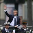 Emmanuel Macron (costume "Jonas &amp; Cie" (rue d'Aboukir à Paris) à 450 Euros) salue les français sur l'avenue des Champs Elysées à Paris le 14 Mai 2017.