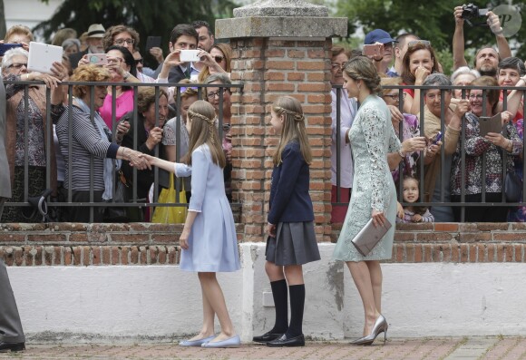 La princesse Leonor et l'infante Sofia saluent la foule avec leur mère la reine Letizia lors de la première communion de l'infante Sofia d'Espagne, le 17 mai 2017 à Madrid.