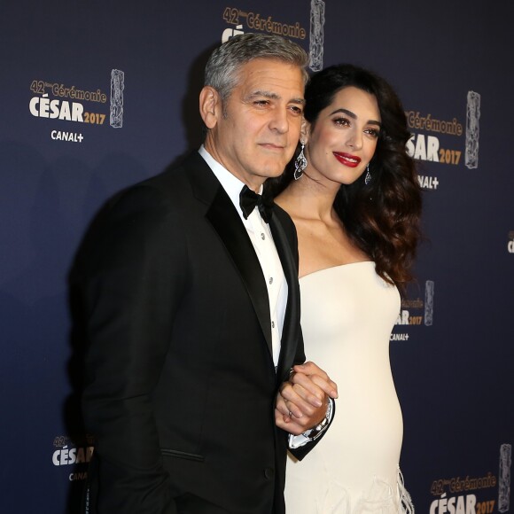 George Clooney (montre Omega) et sa femme Amal Alamuddin-Clooney (enceinte) arrivant à la 42e cérémonie des César à la Salle Pleyel à Paris le 24 février 2017. © Olivier Borde / Dominique Jacovides / Bestimage