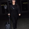 Kourtney Kardashian arrive à l'aéroport de LAX à Los Angeles après un séjour à Paris. La star de téléréalité est toute de noir vêtue. Elle porte une valise à roulettes Louis Vuitton, le 1er octobre 2017.