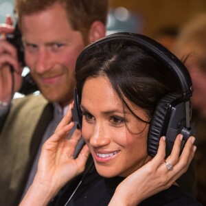 Le prince Harry et sa fiancée Meghan Markle écoutent une émission lors d'une visite à la station de radio Reprezent à Londres le 9 janvier 2018.