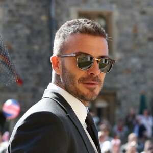 David Beckham et sa femme Victoria arrivent à la chapelle St George pour le mariage du prince Harry et de Meghan Markle au château de Windsor, Royaume Uni, le 19 mai 2018.