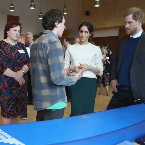 Le prince Harry et Meghan Markle (désormais duchesse de Sussex) en visite à Belfast le 23 mars 2018. En découvrant des articles de puériculture innovant de la marque Shnuggle, Meghan a déclaré : "A un moment donné, on aura besoin de toute la panoplie", faisant allusion à son désir d'avoir des enfants avec le prince.