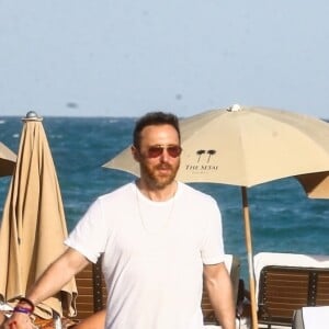 Le DJ David Guetta et le DJ Cédric Gervais accompagnés de leur girlfriend respective sur une plage à Miami, le 09 mars 2019.