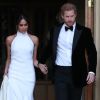 Le prince Harry, duc de Sussex, et Meghan Markle, duchesse de Sussex, habillée d'une robe Stella McCartney et portant une bague sertie d'une aigue-marine ayant appartenu à Lady Diana, quittant le château de Windsor après la réception offerte par Elizabeth II pour rejoindre à bord d'une Jaguar E-Type Concept Zero immatriculée "190518" Frogmore House où avait lieu la réception de leur mariage, le 19 mai 2018.