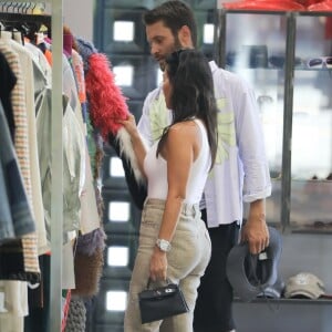 Kourtney Kardashian porte un petit haut blanc sans soutien-gorge au cours d'une séance shopping avec Simon Porte Jacquemus et une amie. West Hollywood, Los Angeles le 20 août 2019.