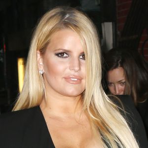 Jessica Simpson porte une robe noire très moulante et laisse entrevoir son soutien-gorge en dentelle à la sortie d'un hôtel à New York, le 25 septembre 2019