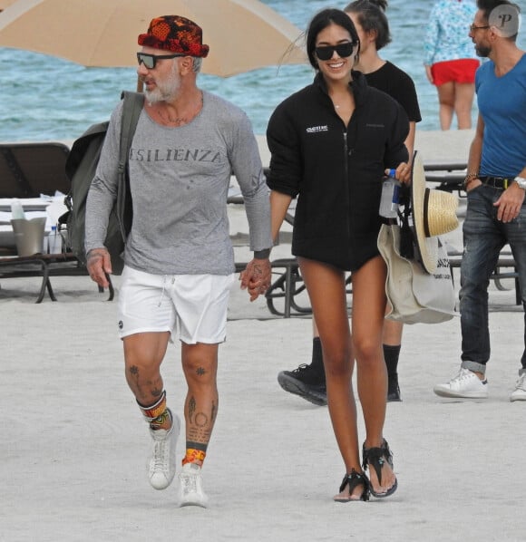 Exclusif - Gianluca Vacchi et sa compagne Sharon Fonseca passent une journée romantique sur une plage à Miami. Alors que sa carrière musicale vient de prendre un nouveau tournant, l'Italien aux 11 millions d'abonnés sur Instagram peaufine son bronzage sur les plages de Miami en bonne compagnie! Son premier single Love, réalisé avec le chanteur colombien Sebastián Yatra et le duo de producteurs Andres Torres et Mauricio Rengifo (à l'origine de l'incontournable Despacito) est sorti le 20 avril dernier. La belle est la première fan de son copain musclé, puisqu'elle n'a pas hésité à partager des extraits de sa nouvelle chanson avec sa propre communauté Instagram. On peut d'ailleurs l'apercevoir dans les extraits du clip qui accompagne le titre Love. L'occasion pour elle, et les quelques autres mannequins en bikini, de se joindre à Gianluca Vacchi pour quelques déhanchés dénudés! Le 20 novembre 2018