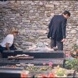  Alain Delon et Mireille Darc sur la tombe de Romy Schneider à Boissy-sans-Avoir dans les Yvelines, en 1982.  