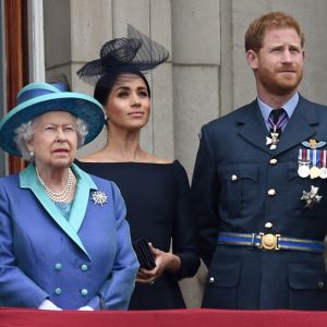La reine Elisabeth II d'Angleterre, Meghan Markle, duchesse de Sussex (habillée en Dior Haute Couture par Maria Grazia Chiuri), le prince Harry, duc de Sussex lors de la parade aérienne de la RAF pour le centième anniversaire au palais de Buckingham à Londres.