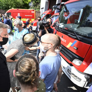 Le roi Philippe et la reine Mathilde de Belgique rendent hommage aux victimes des inondations à Verviers, le 20 juillet 2021, lors de la journée de de deuil national en Belgique.