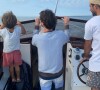 Jérémy Frérot et son fils Lou sur un bateau en pleine mer, le 23 août 2021.