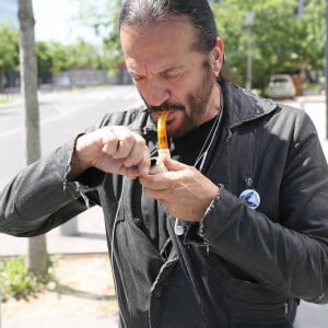 Le chanteur Francis Lalanne fume la pipe à la sortie des studios RMC à Paris, France, le 11 juin 2021. © Panoramic/Bestimage