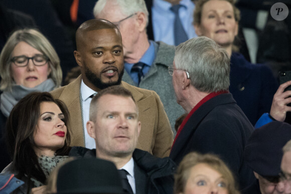 Patrice Evra et Sir Alex Ferguson dans les tribunes du stade Old Trafford lors du match de 8ème de finale aller de Ligue des champions opposant le Paris Saint-Germain à Manchester Unted à Manchester, Royaume Uni, le 12 février 2019. Le PSG a gagné 2-0.