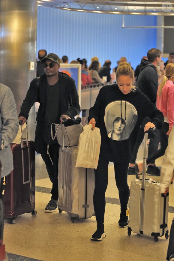 Exclusif - Le footballeur international français qui évolue au poste de défenseur à West Ham United Patrice Evra et sa femme Sandra arrivent à l'aéroport de LAX à Los Angeles le 21 mai 2018.