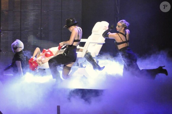 Quand elle joue les flicquettes sexy en combi cuir rouge sur un divan, Lady Gaga... on ne lui résiste pas lors de son show à l'Université Centrale de Floride le 3 janvier 2010 !