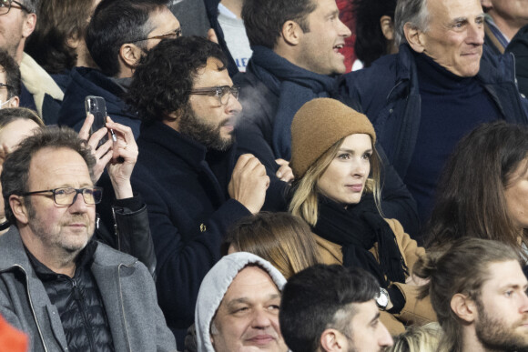 Maxim Nucci (Yodelice) et sa compagne Isabelle Ithurburu assistent à la rencontre de rugby opposant la France à l'Angleterre, au stade de France, dans le cadre du Tournoi des Six Nations. Saint-Denis, le 19 mars 2022. © Cyril Moreau/Bestimage