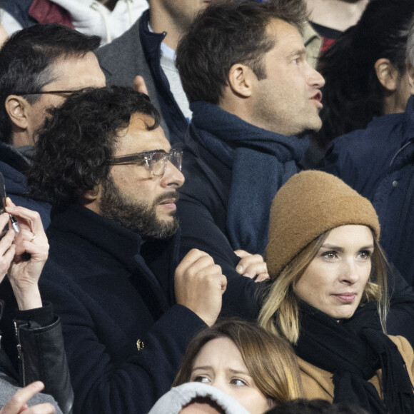 Maxim Nucci (Yodelice) et sa compagne Isabelle Ithurburu assistent à la rencontre de rugby opposant la France à l'Angleterre, au stade de France, dans le cadre du Tournoi des Six Nations. Saint-Denis, le 19 mars 2022. © Cyril Moreau/Bestimage
