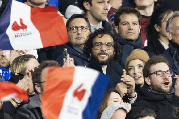 Maxim Nucci (Yodelice) et sa compagne Isabelle Ithurburu assistent à la rencontre de rugby opposant la France à l'Angleterre, au stade de France, dans le cadre du Tournoi des Six Nations. Saint-Denis, le 19 mars 2022. © Cyril Moreau/Bestimage