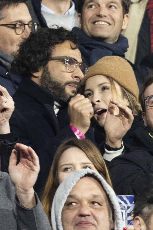 Maxim Nucci (Yodelice) et sa compagne Isabelle Ithurburu assistent à la rencontre de rugby opposant la France à l'Angleterre, au stade de France, dans le cadre du Tournoi des Six Nations. Saint-Denis, le 19 mars 2022. © Cyril Moreau/Bestimage