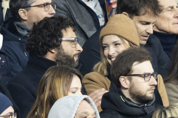 Maxim Nucci (Yodelice) et sa compagne Isabelle Ithurburu assistent à la rencontre de rugby opposant la France à l'Angleterre, au stade de France, dans le cadre du Tournoi des Six Nations. Saint-Denis, le 19 mars 2022. © Cyril Moreau/Bestimage