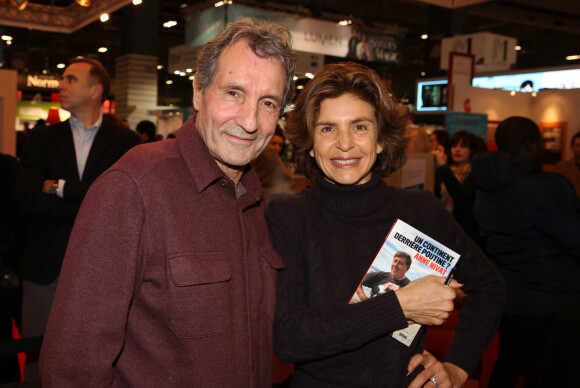 Jean-Jacques Bourdin et sa femme Anne Nivat lors du salon du livre de Paris le 17 Mars 2018 à la Porte de Versailles de Paris.