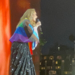 Adèle donne un concert à Hyde Park, en marge de la London Pride Parade, un drapeau aux couleurs LGBT sur les épaules. Le 2 juillet 2022. 