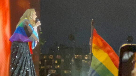 Adèle donne un concert à Hyde Park, en marge de la London Pride Parade, un drapeau aux couleurs LGBT sur les épaules. Le 2 juillet 2022. 