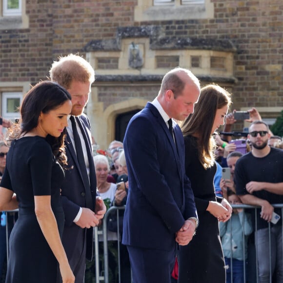 Le prince de Galles William et la princesse de Galles Kate Catherine Middleton et le prince Harry, duc de Sussex et Meghan Markle, duchesse de Sussex à la rencontre de la foule devant le château de Windsor, suite au décès de la reine Elisabeth II d'Angleterre. Le 10 septembre 2022 