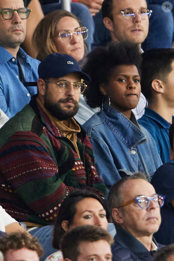 Hakim Jemili et sa femme Fadily Camara - People dans les tribunes du match de Ligue des champions entre le PSG et le Borussia Dortmund (2-0) au Parc des Princes à Paris le 19 septembre 2023. © Cyril Moreau/Bestimage