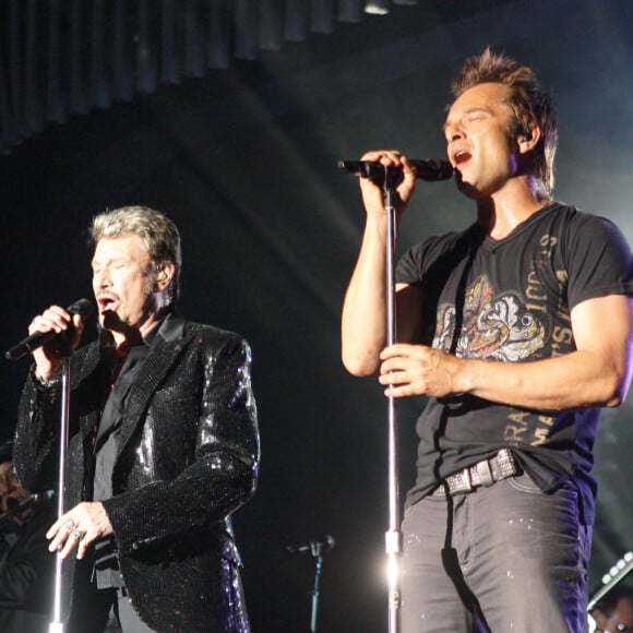 David Hallyday et Johnny Hallyday en concert au Sporting de Monaco pendant la tournée "Tour 66" 