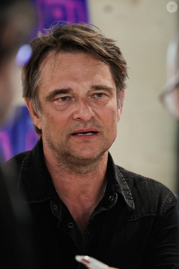 David Hallyday signs his book at the Paris Book Festival, at the ephemeral Grand Palais on April 14, 2024. Photo By Thibaud MORITZ/ABACAPRESS.COM 