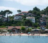 C'est là bas qu'il habite depuis les années 1970. 
Lege-Cap-Ferret (33), L'Herbe : vue sur les maisons du bord de mer et touristes sur la plage dans le bassin d'Arcachon - Photo by Delmarty J/ANDBZ/ABACAPRESS.COM -