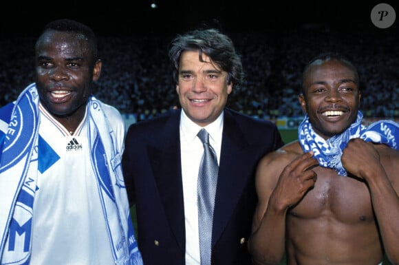 "Basile Boli te rend visite. Depuis toujours, il vient voir 'le boss'", écrit Marie Griessinger-Tapie

Archives - Basile Boli, Bernard Tapie et Abedi Pelé - © Panoramic/Bestimage