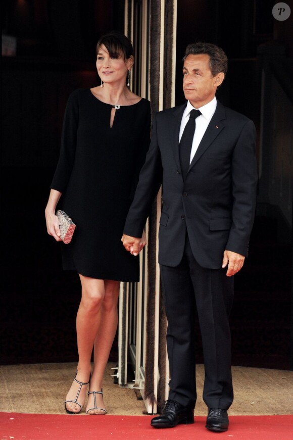 Carla Bruni-Sarkozy cache ses rondeurs de future maman dans une robe ample et noire. Ravissant et très élégant. Deauville, 26 mai 2011