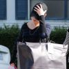 Mila Kunis, cachée par sa casquette, sort d'une séance shopping fructueuse. Beverly Hills, le 15 novembre 2011.