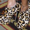 Nicole Richie, fondatrice du label House Of Harlow 1960, a également élaboré des chaussures imprimés léopard qu'elle portait à New York, laissant entrevoir son tatouage à la cheville. Le 13 octobre 2011.