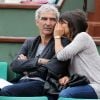 Estelle Denis et Raymond Domenech assistent au 6e jour du tournoi de Roland-Garros, le vendredi 1er juin 2012.