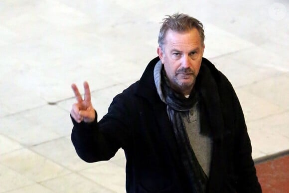 Kevin Costner fatigué salue les paparazzis lors de son arrivée à l'aeroport Charles-de-Gaulle, le 15 janvier 2013.