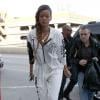 Rihanna, habillée d'une combinaison DKNY for Opening Ceremony, de souliers Alexander Wang et d'un sac Joyrich, arrive à l'aéroport de Los Angeles pour prendre un vol à destination de Londres. Le 3 mars 2013.