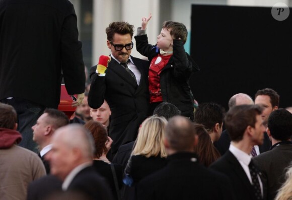Robert Downey Jr. avec un jeune fan à la première d'Iron Man 3 à l'Odeon Leicester Square, Londres, le 18 avril 2013.