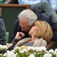 Dominique Strauss-Kahn et sa compagne Myriam L'Aouffir dans les tribunes du tournoi de Roland-Garros 2013 pour la finale opposant Rafael Nadal à David Ferrer, à Paris le 9 juin 2013.
