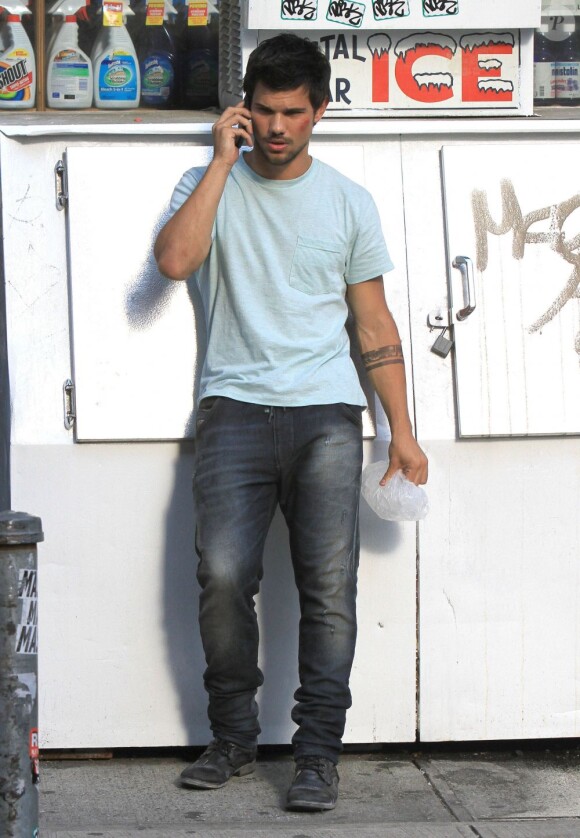 Taylor Lautner blessé au téléphone sur le tournage du film Tracers à New York, le 24 Juin 2013.