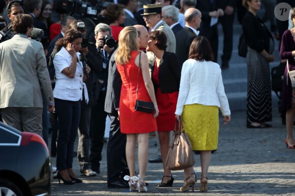 Pierre Moscovici et sa compagne Marie-Charline Pacquot au défilé du 14 juillet 2013 à Paris.