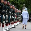 Elizabeth II lors de la revue des troupes des Royal Scots Borderers (1 Scots) à Balmoral, en compagnie du Major Jules Kilpatrick, le 8 août 2013.