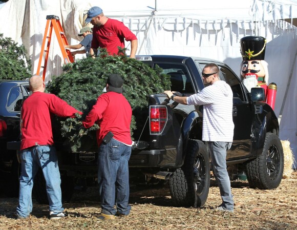 Martin Kirsten, le compagnon d'Heidi Klum, charge deux sapins de Noël à l'arrière d'un pick-up noir. West Hollywood, le 30 novembre 2013.