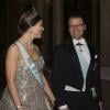 La princesse Victoria et le prince Daniel de Suède arrivent pour le dîner offert au palais royal en l'honneur des lauréats des prix Nobel, le 11 décembre 2013 à Stockholm