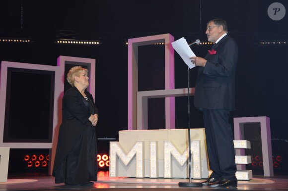 Mimie Mathy a reçu les insignes de Chevalier de l'Ordre National du Mérite des mains de Jean-Claude Camus à l'issue de son spectacle "Je re-papote avec vous" au théâtre de la Porte Saint-Martin à Paris, le 13 decembre 2013.