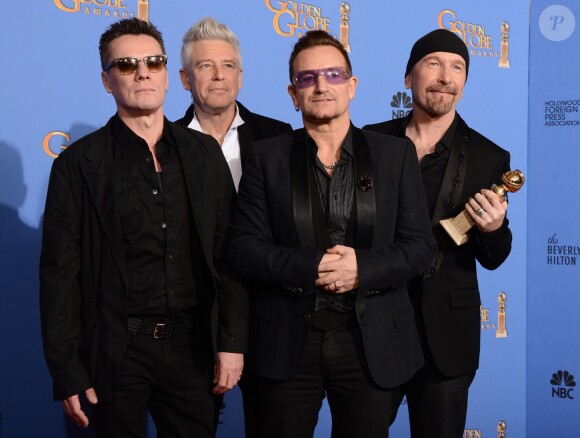 Larry Mullen Jr., Bono, Adam Clayton et The Edge de U2 avec leur prix pour la meilleure chanson (Ordinary Love) lors des Golden Globes à Los Angeles le 12 janvier 2014